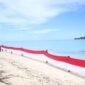 Aksi pembentangan bendera merah putih sepanjang 80 meter di wilayah Maritim dekat Pulau Jiew, yang mencakup Pulau Liwo dan Pulau Sayafi. || dok : Sukarsi/Kasedata